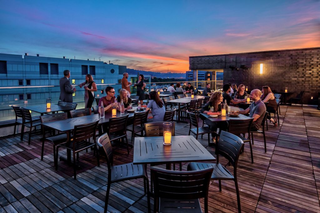 A scenic rooftop deck at the Eliza Hotel Indigo, offering stunning views of the city skyline in Pittsburgh.